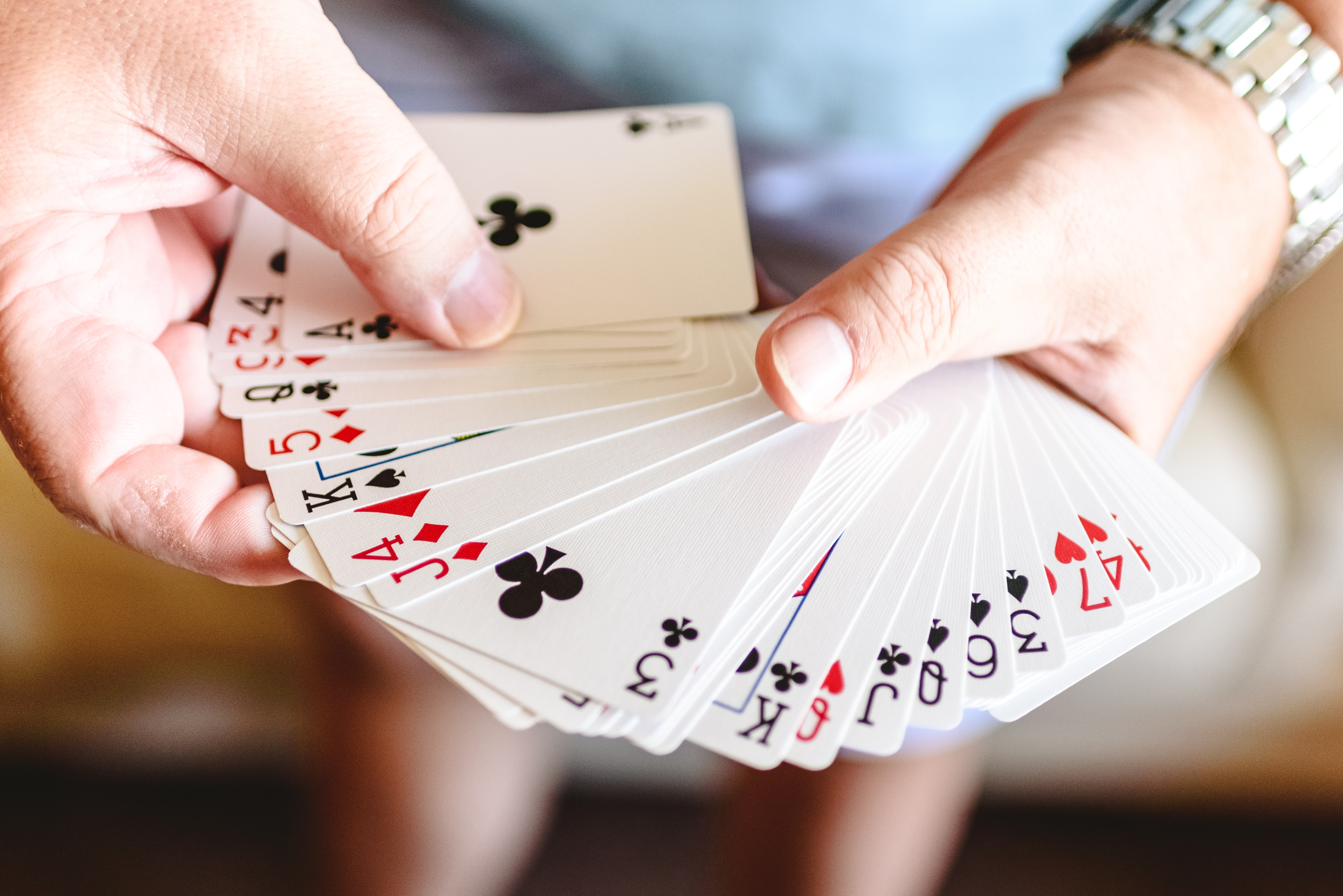  Hands Doing Magic Trick with Playing Cards.